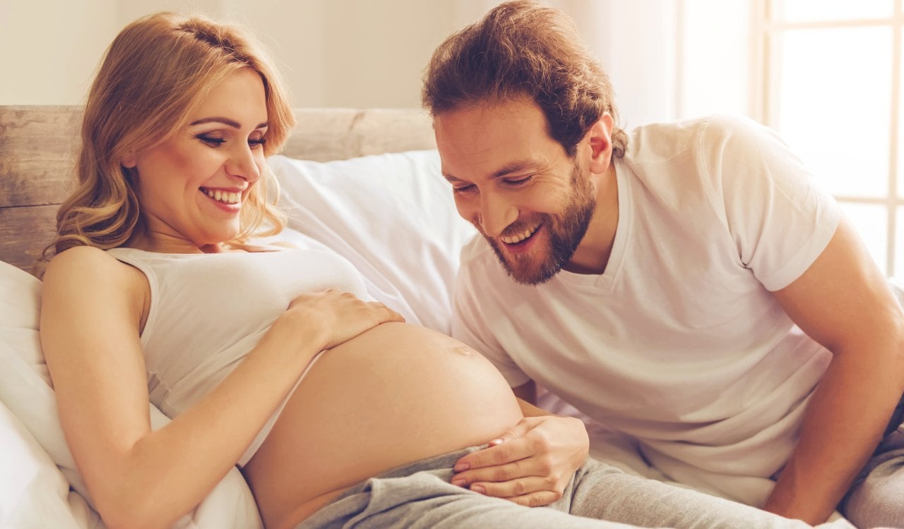 Pregnant Woman Smiling With Partner